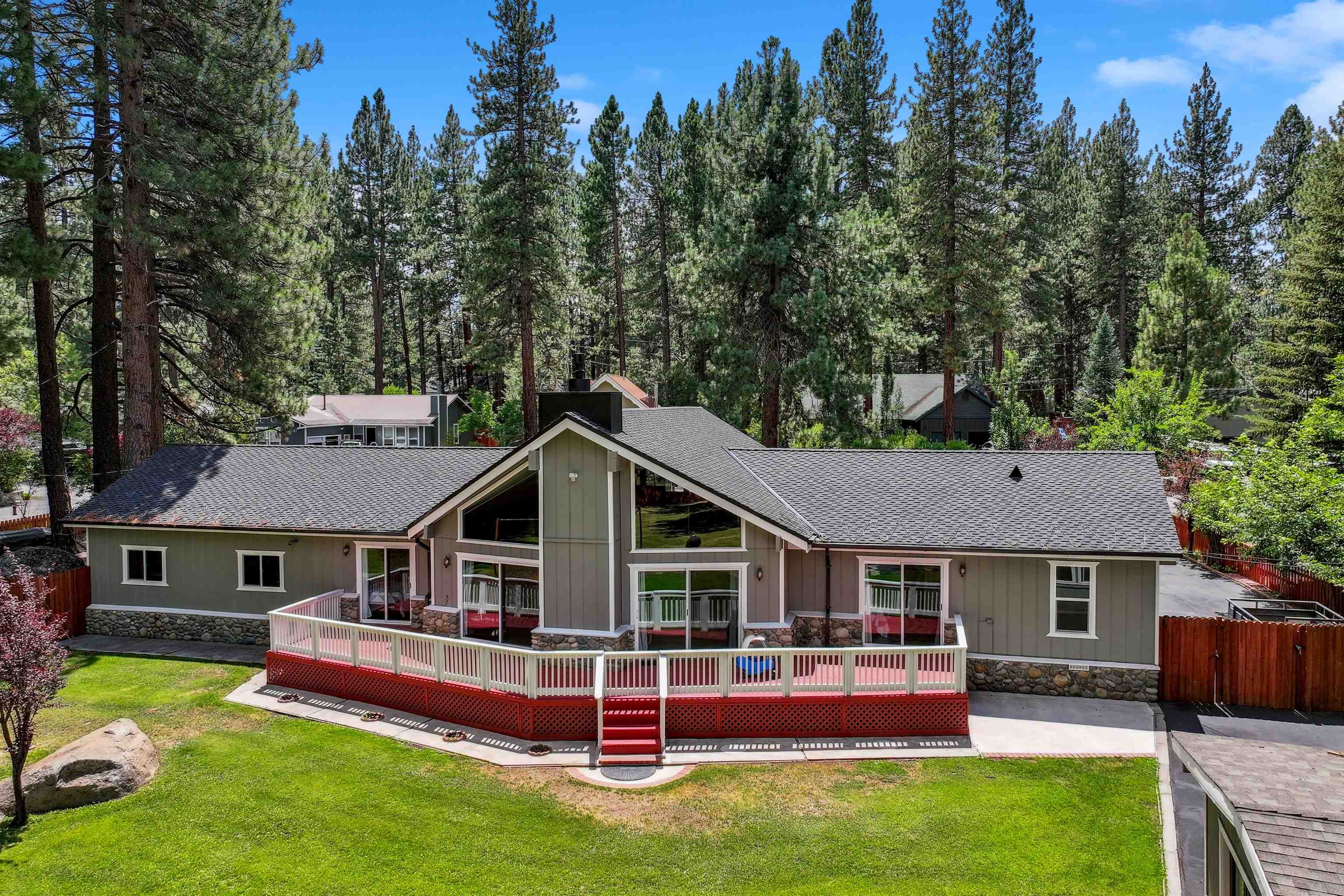 aerial view of a house with a yard patio and fire pit