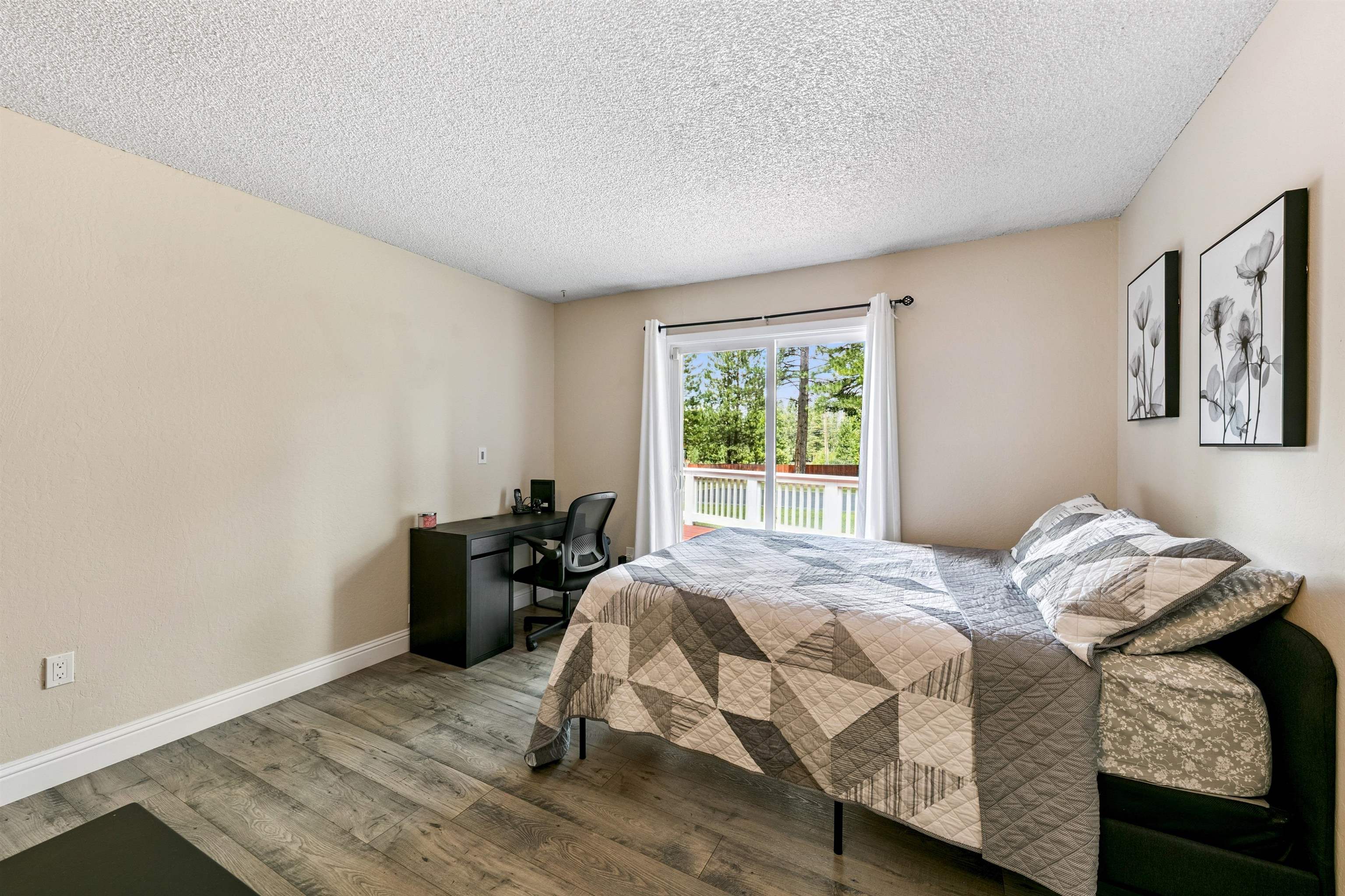 10228 Jeffery Pine Road Truckee, CA 96161 - Photo 17 of 28 a bedroom with a bed and wooden floor