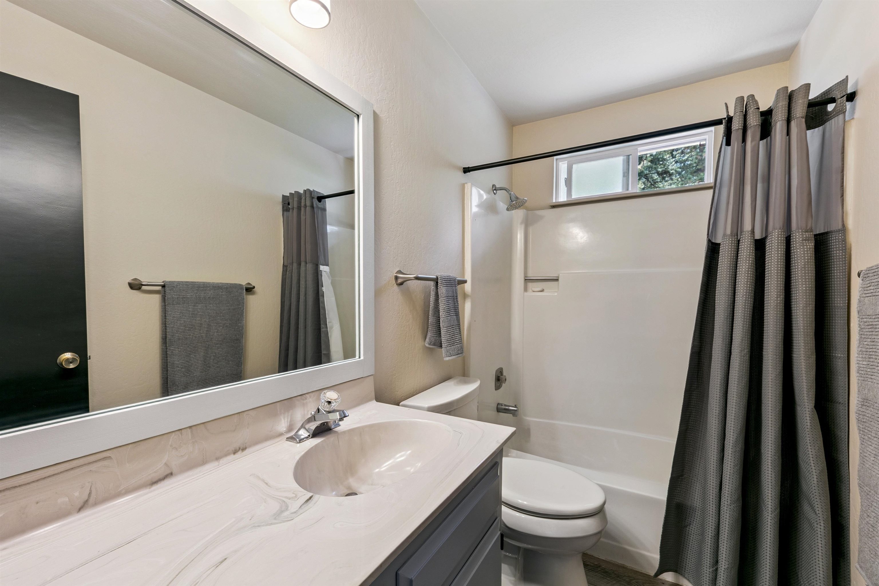 10228 Jeffery Pine Road Truckee, CA 96161 - Photo 18 of 28 a bathroom with a granite countertop sink toilet and shower