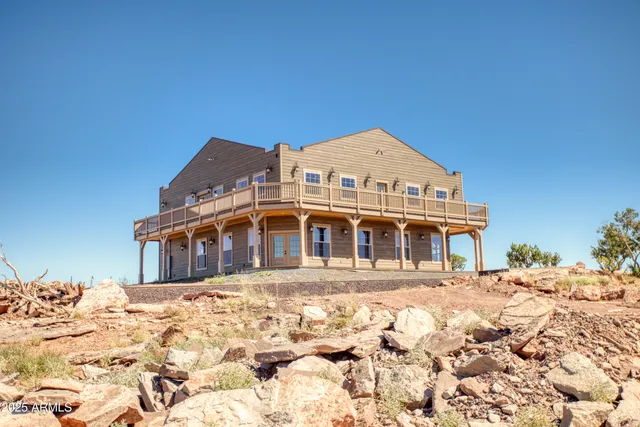 a view of a balcony with wooden floor and fence