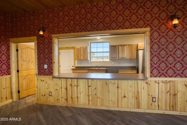 a view of a livingroom with a ceiling fan and window