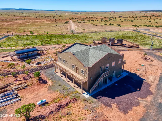 a front view of a house with a yard and ocean view