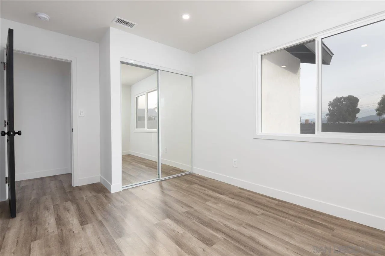 9469 Terrywood Road Santee, CA 92071 - Photo 11 of 25 an empty room with wooden floor and a bathroom
