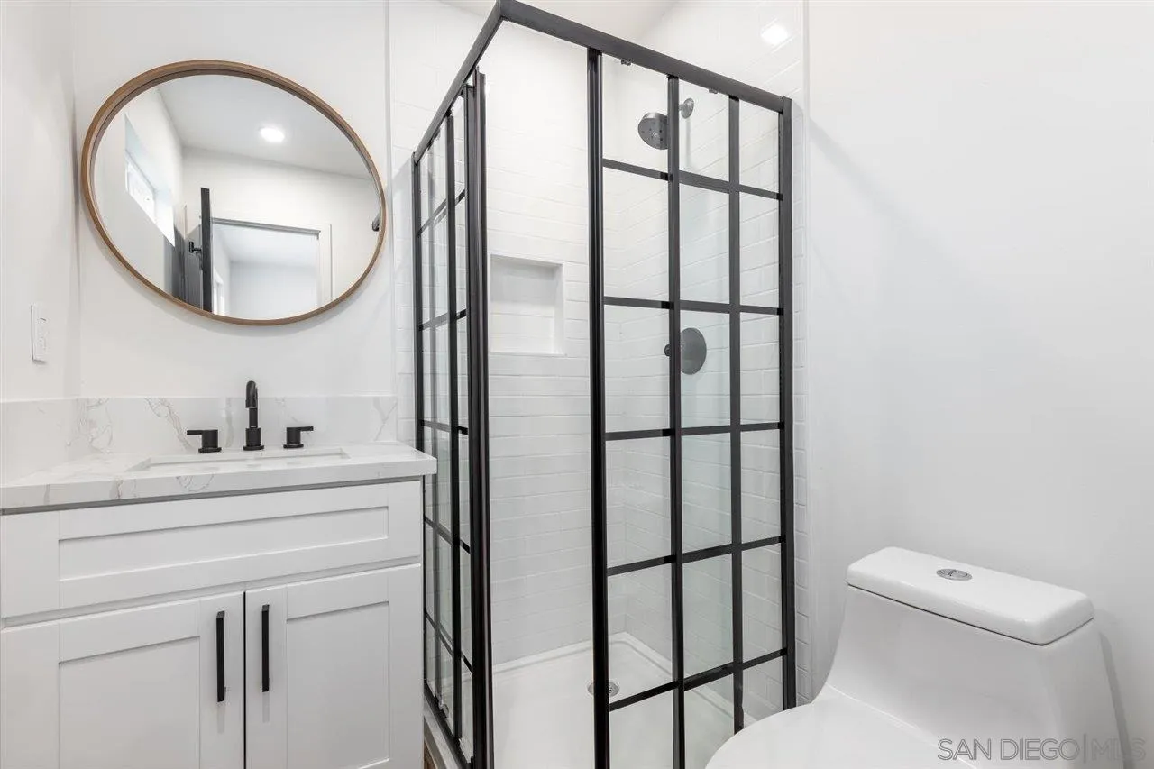 9469 Terrywood Road Santee, CA 92071 - Photo 15 of 25 a bathroom with a toilet a sink and a mirror