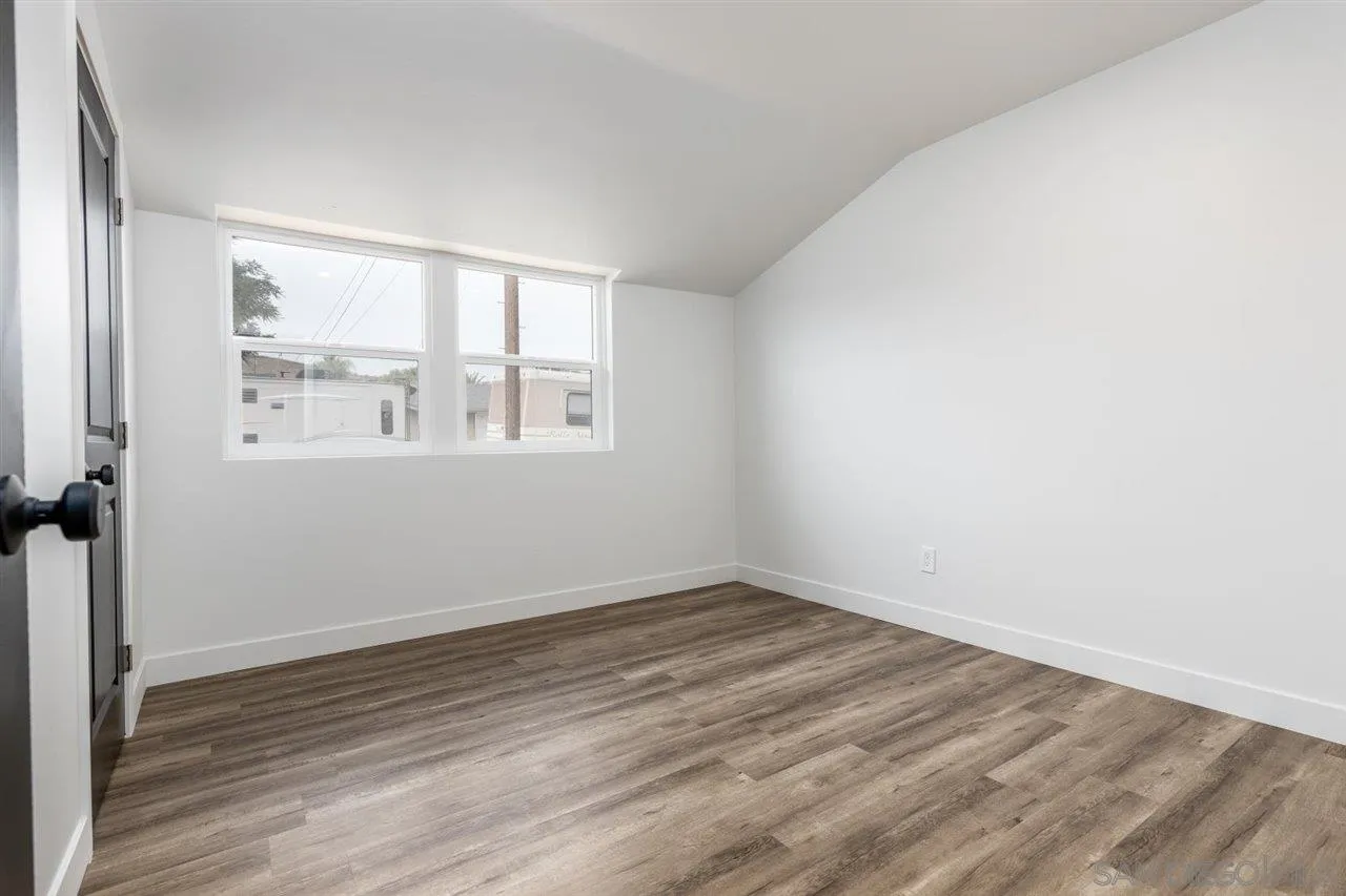 9469 Terrywood Road Santee, CA 92071 - Photo 17 of 25 an empty room with wooden floor and windows