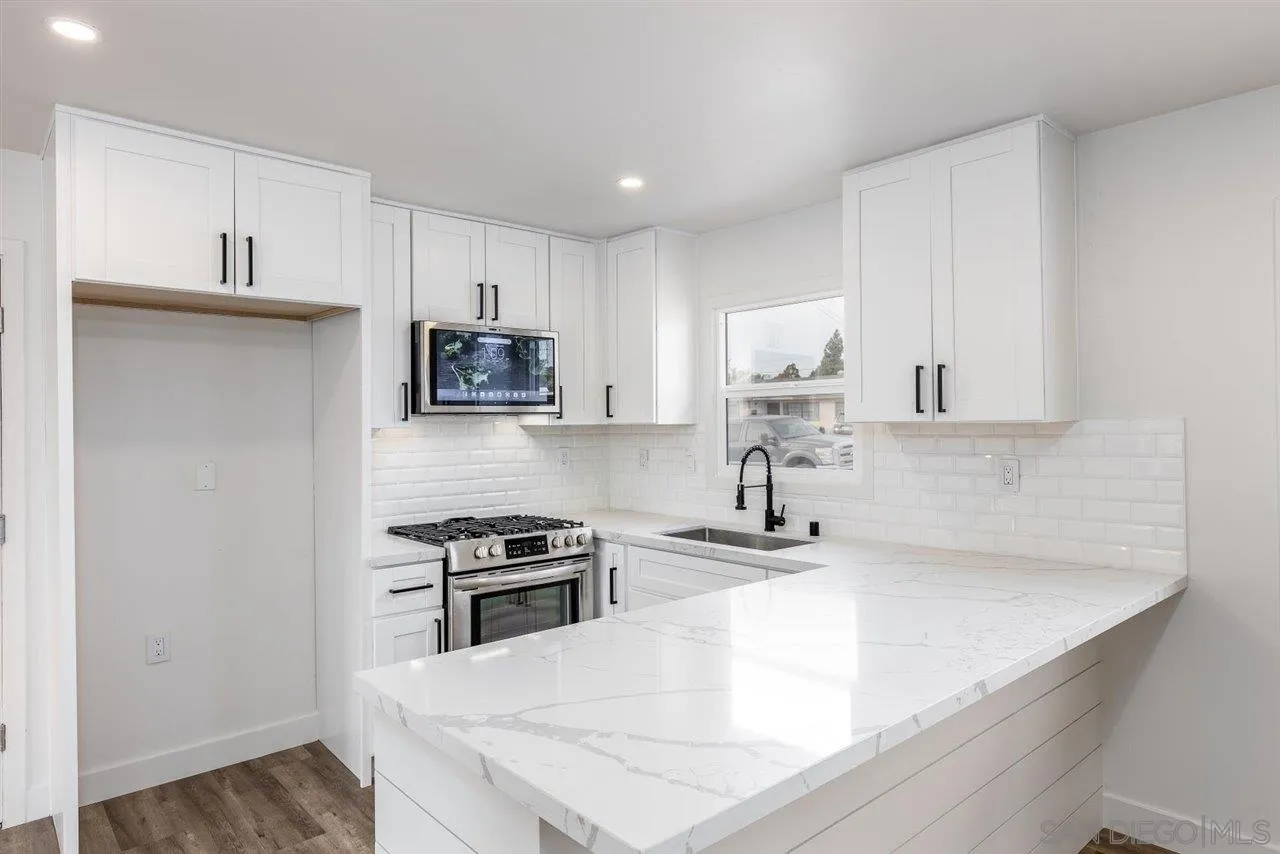 9469 Terrywood Road Santee, CA 92071 - Photo 3 of 25 a kitchen with granite countertop a sink a stove and refrigerator