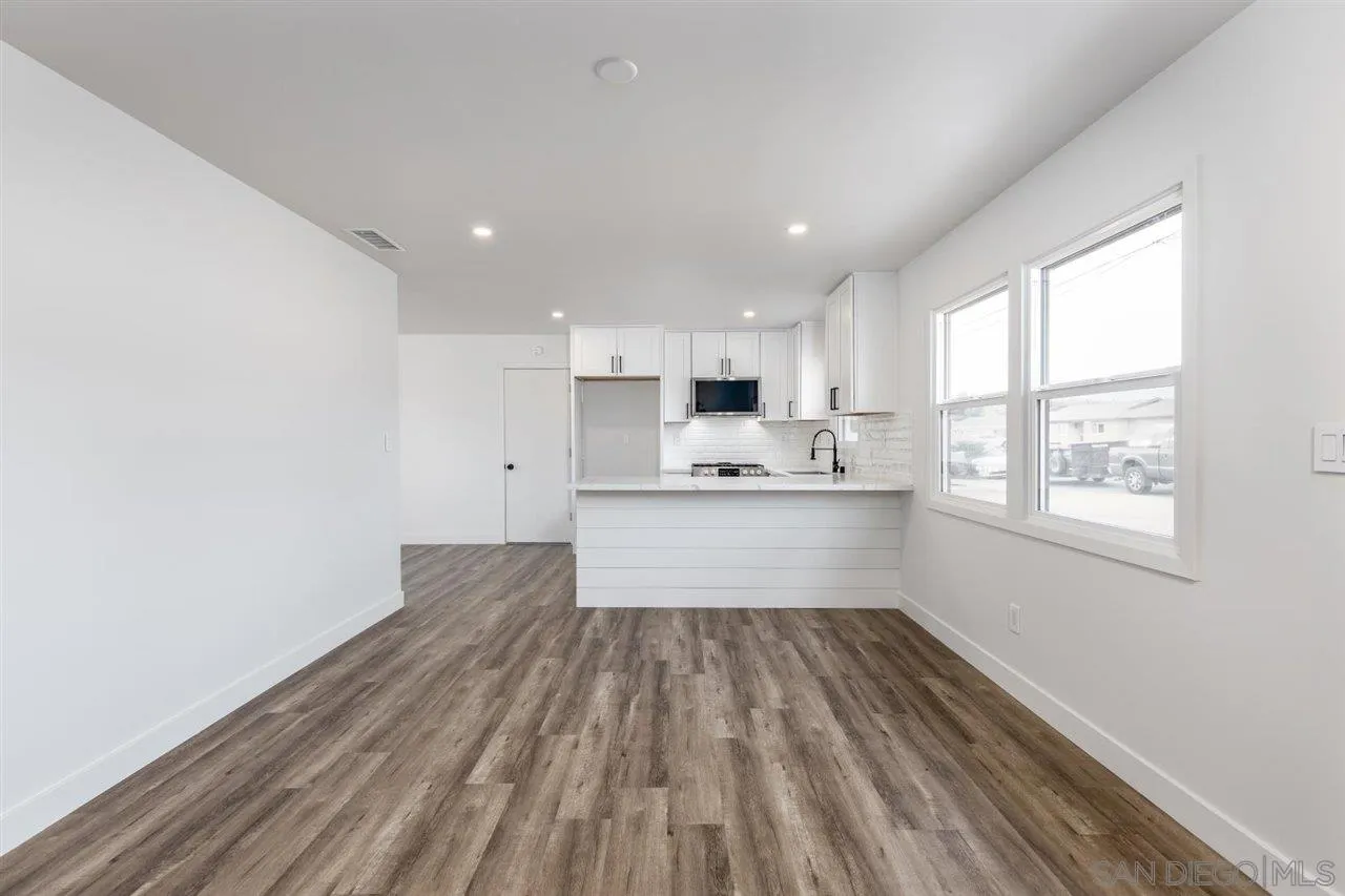 9469 Terrywood Road Santee, CA 92071 - Photo 6 of 25 a large kitchen with wooden floor and a window