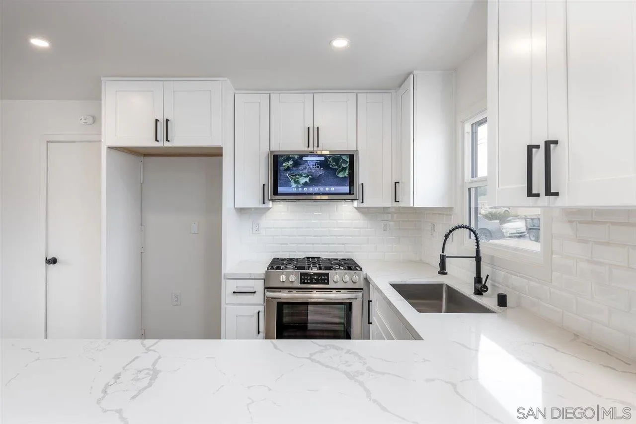 9469 Terrywood Road Santee, CA 92071 - Photo 7 of 25 a kitchen with stainless steel appliances a stove a sink and a microwave