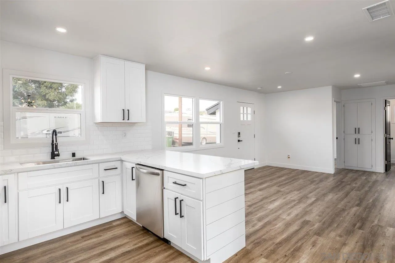 9469 Terrywood Road Santee, CA 92071 - Photo 8 of 25 a kitchen with a sink window and cabinets