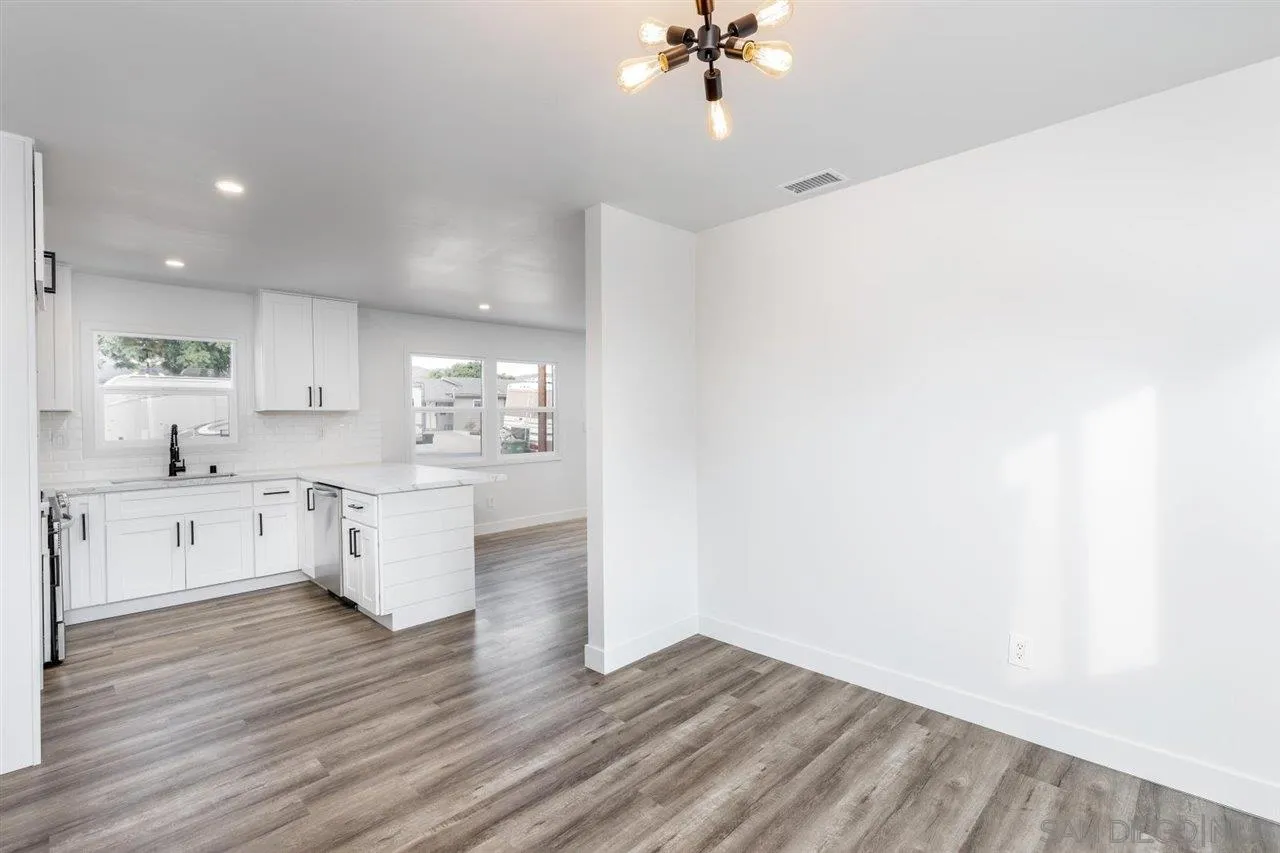 9469 Terrywood Road Santee, CA 92071 - Photo 9 of 25 a large white kitchen with sink and white cabinets