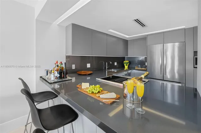 a living room with furniture and kitchen view