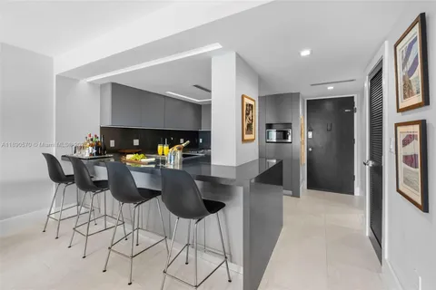 a dining room with furniture and chandelier