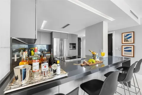 a room with a table chairs and appliances