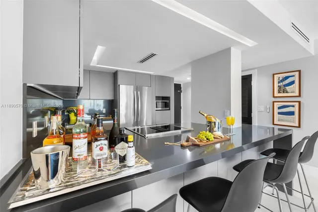 a room with a table chairs and appliances