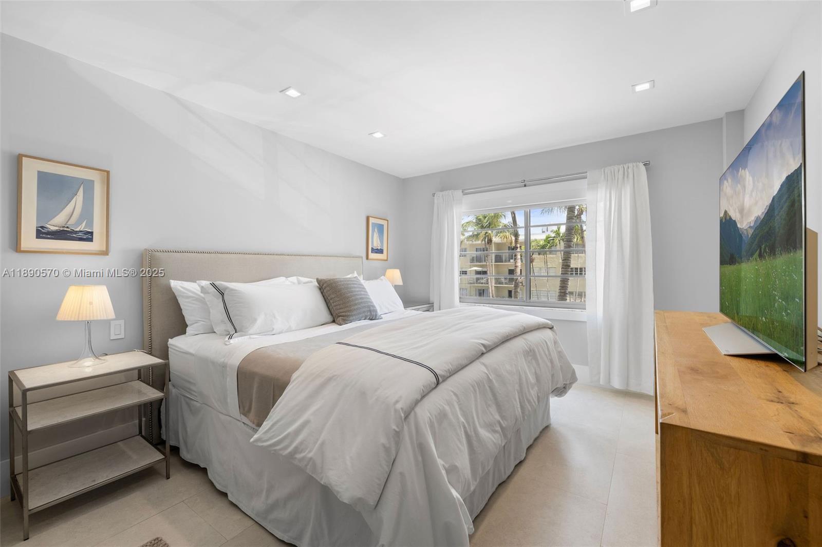 1450 Lincoln Road, Unit 304 Miami Beach, FL 33139 - Photo 21 of 35 a spacious bedroom with a bed and a flat screen tv