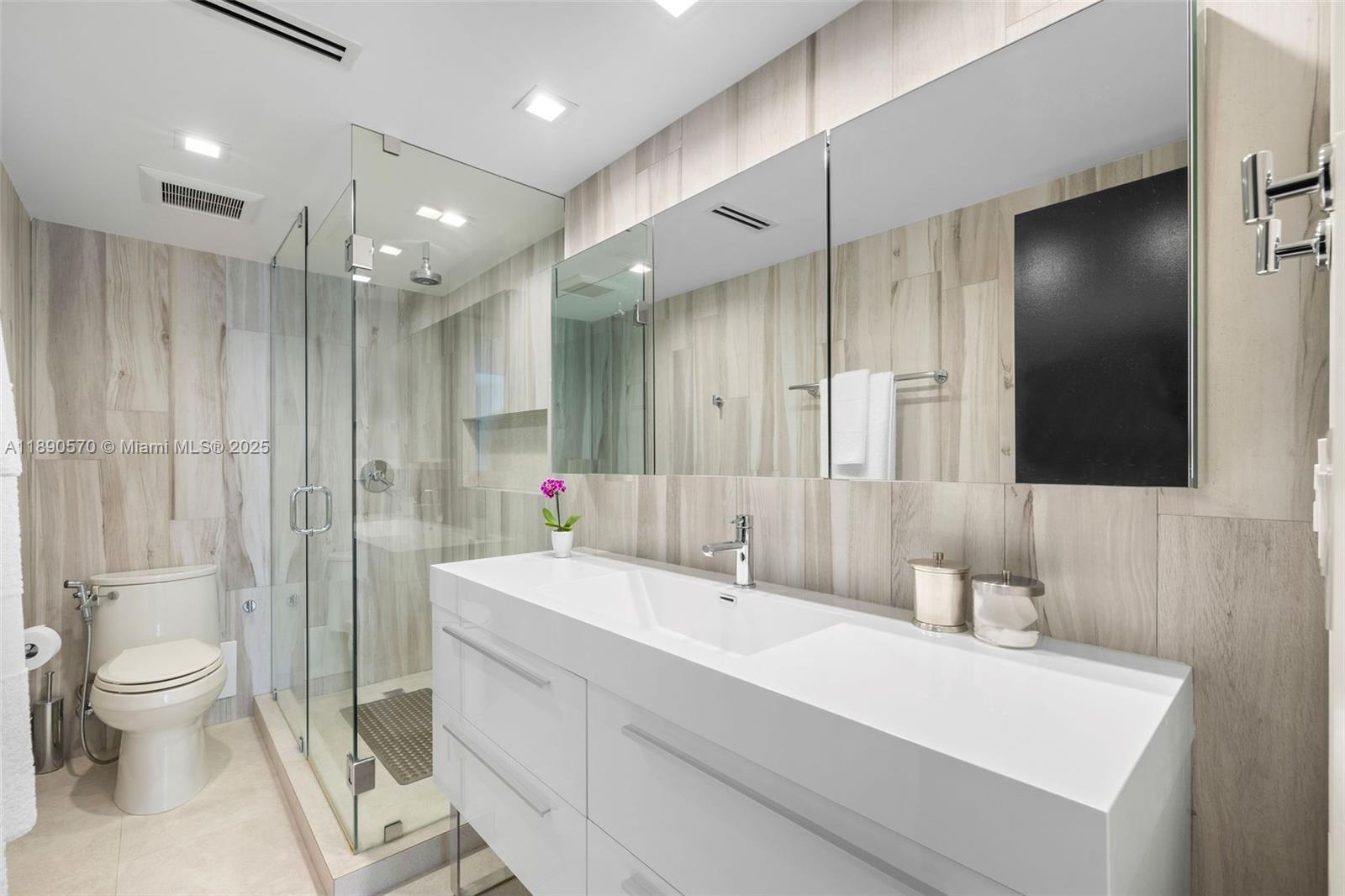 1450 Lincoln Road, Unit 304 Miami Beach, FL 33139 - Photo 24 of 35 a bathroom with a sink a toilet and shower