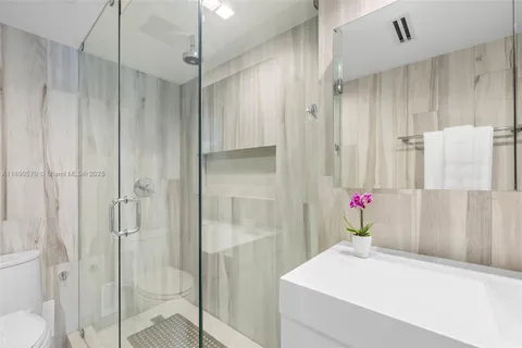a bathroom with a shower and a sink