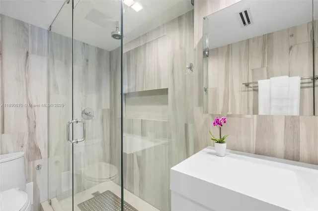 a bathroom with a shower and a sink