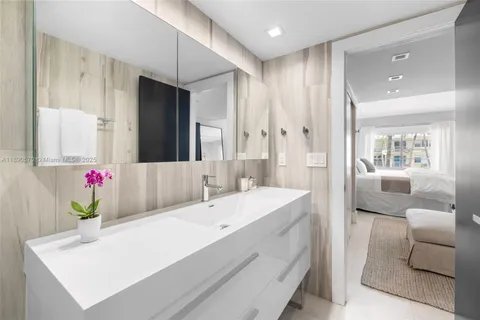 a en suite bathroom with a granite countertop tub and a sink