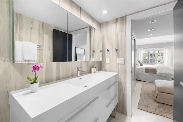 a en suite bathroom with a granite countertop tub and a sink