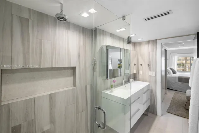 a bathroom with a tub sink shower and mirror