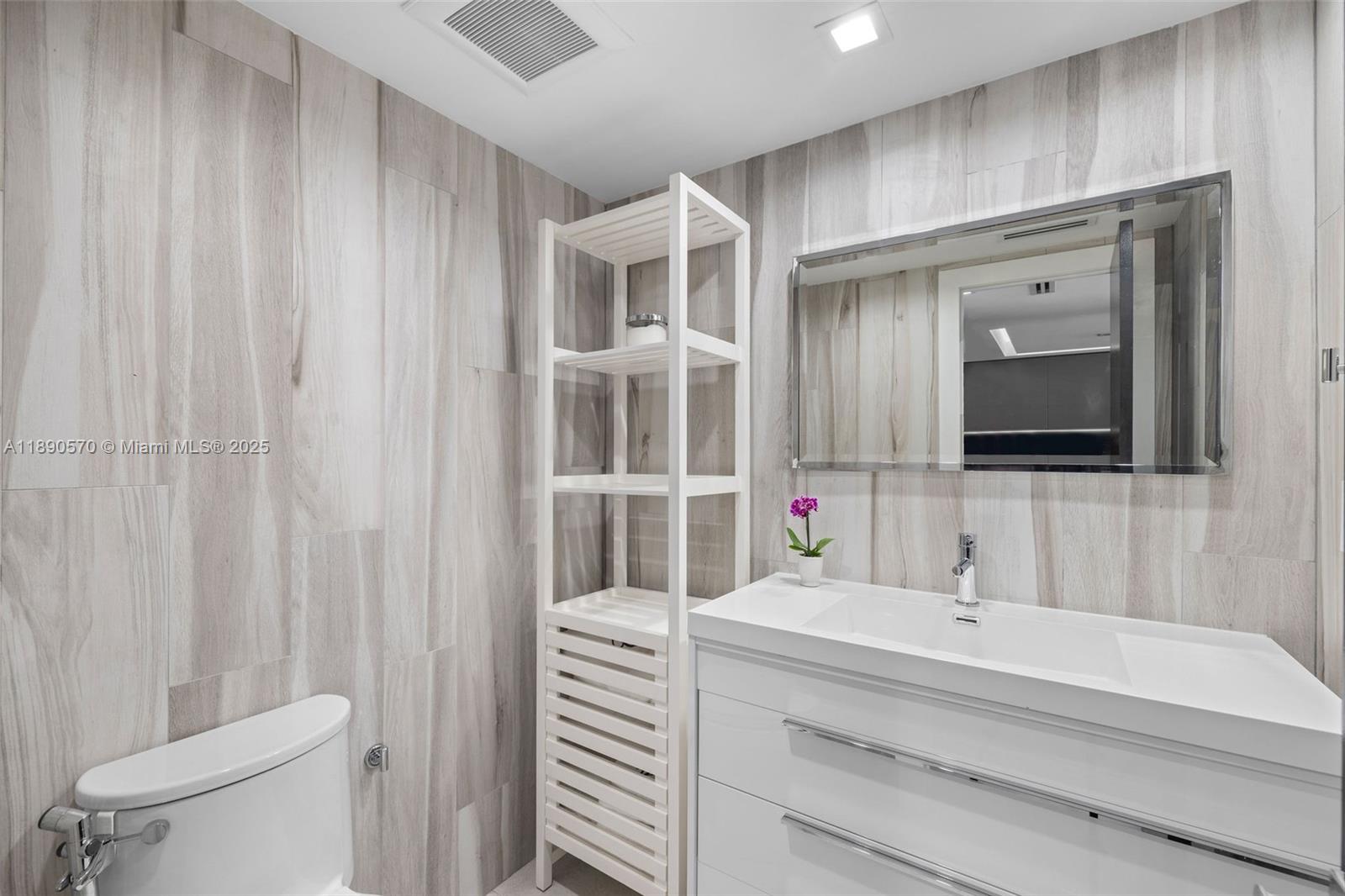 1450 Lincoln Road, Unit 304 Miami Beach, FL 33139 - Photo 28 of 35 a bathroom with a sink and a mirror