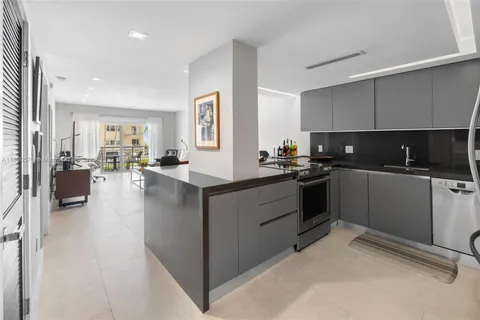 a kitchen with counter top space a sink cabinets and appliances