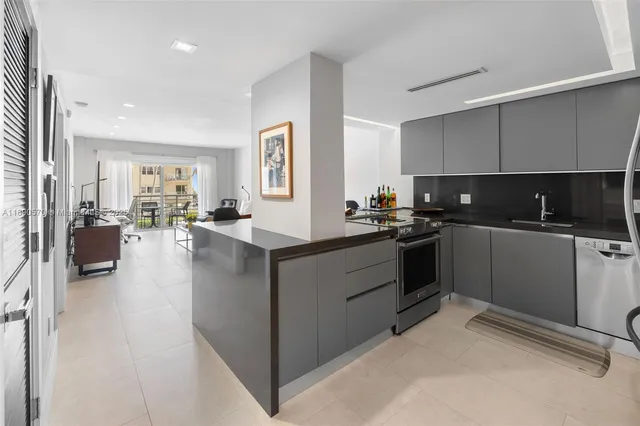 a kitchen with counter top space a sink cabinets and appliances