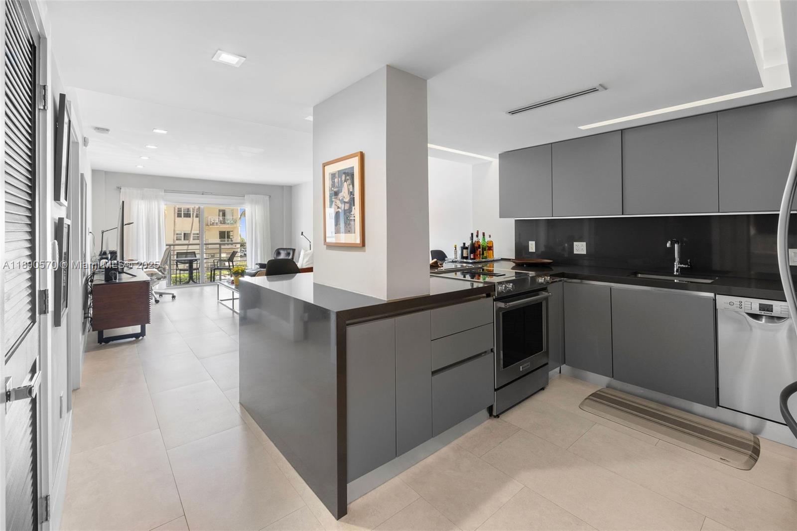 1450 Lincoln Road, Unit 304 Miami Beach, FL 33139 - Photo 9 of 35 a kitchen with counter top space a sink cabinets and appliances