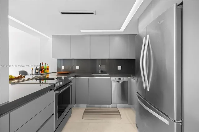 a kitchen with a refrigerator sink and stove