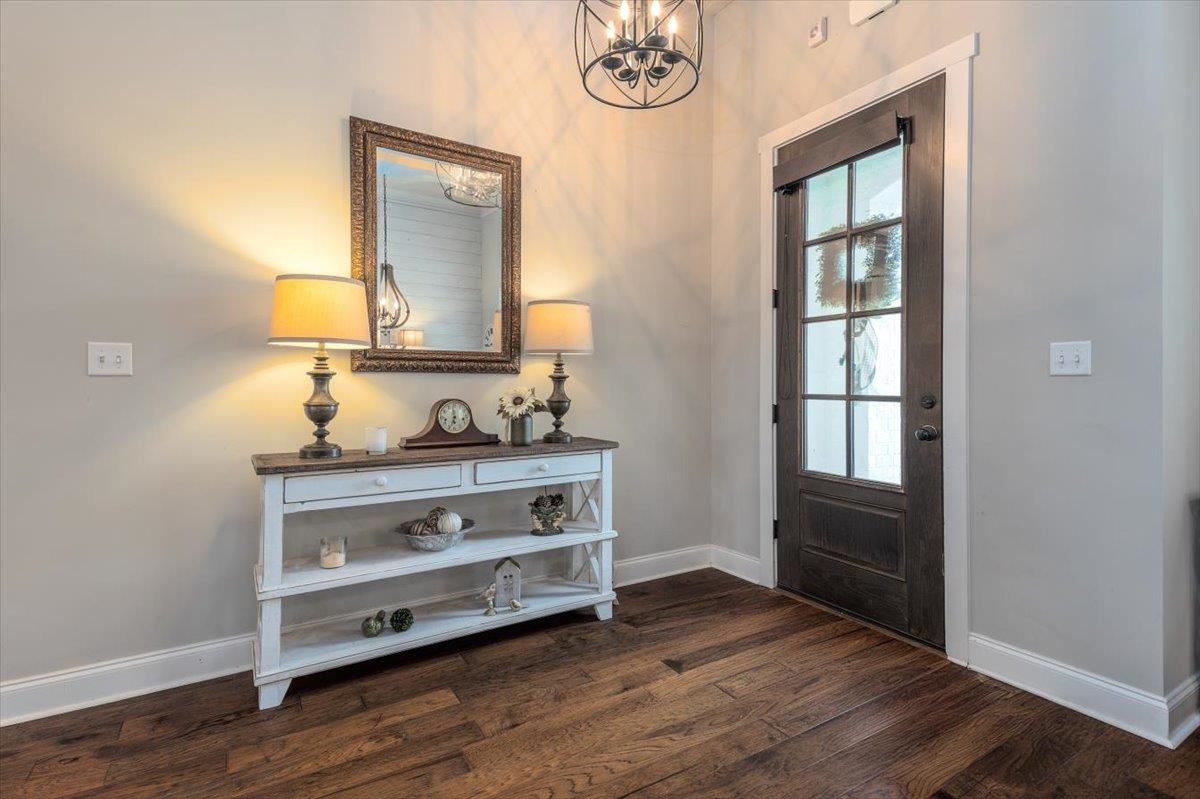608 Cypress Run Cove Collierville, TN 38017 - Photo 5 of 40 Foyer entrance with dark wood-style floors and a chandelier