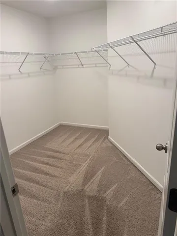 a white toilet sitting next to a white cabinet