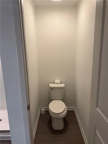 a bathroom with a toilet and a bath tub