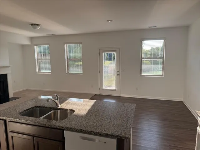 a kitchen with granite countertop a sink and a window
