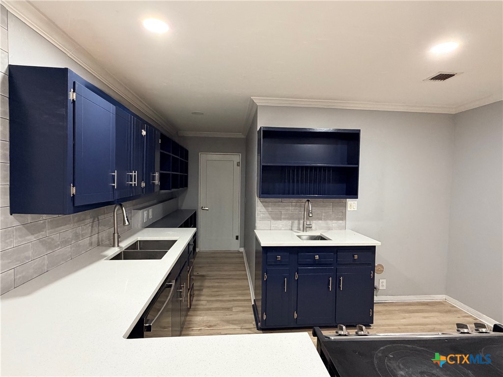 425 Woodland Point Road Belton, TX 76513 - Photo 12 of 27 a kitchen with a sink and a wooden cabinets