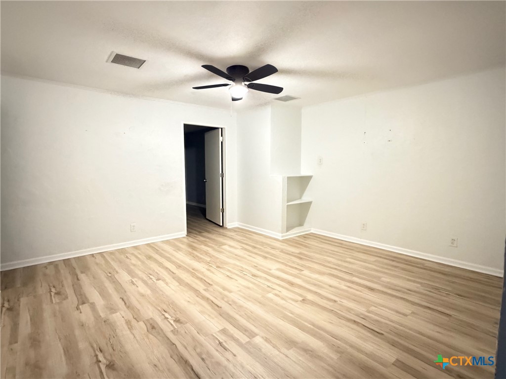425 Woodland Point Road Belton, TX 76513 - Photo 15 of 27 a view of empty room with wooden floor and fan