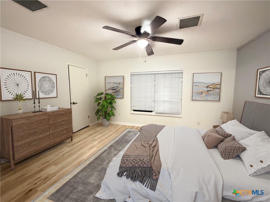 425 Woodland Point Road Belton, TX 76513 - Photo 16 of 27 a bedroom with a bed and a dresser