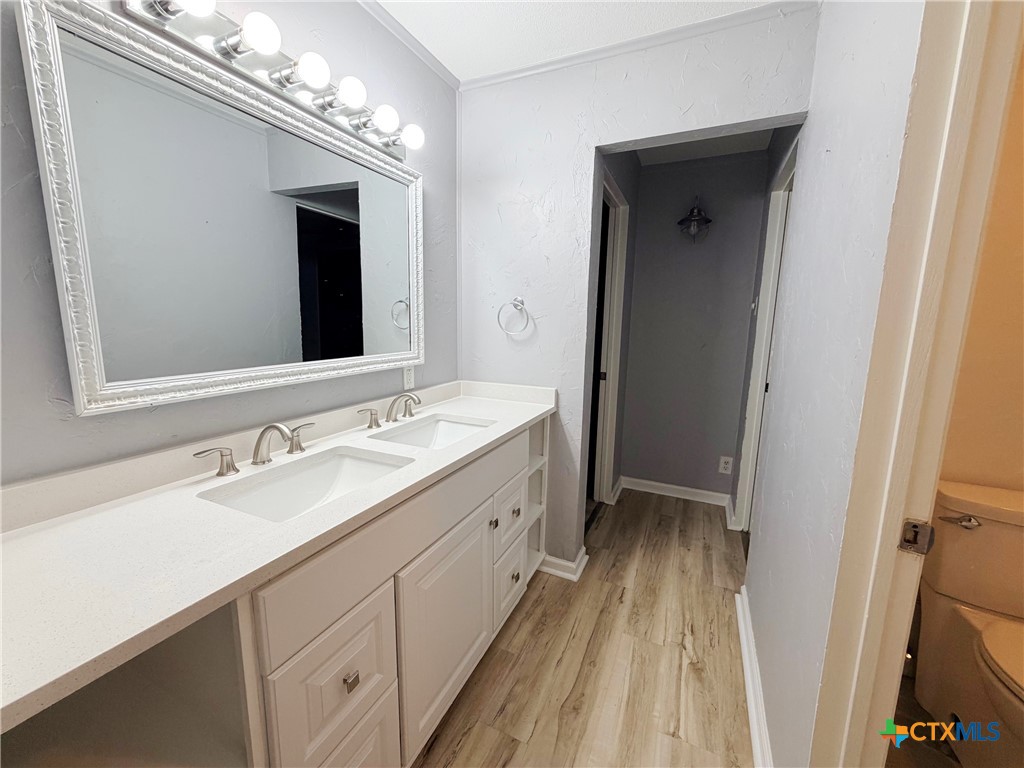 425 Woodland Point Road Belton, TX 76513 - Photo 19 of 27 a spacious bathroom with a double vanity sink and a mirror