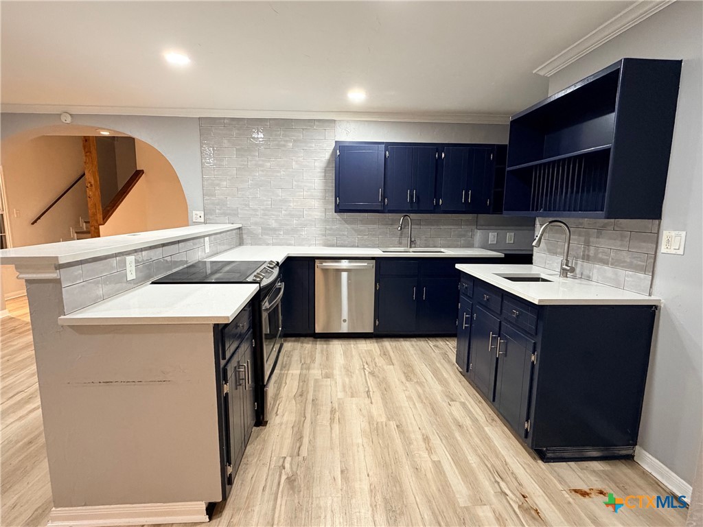 425 Woodland Point Road Belton, TX 76513 - Photo 3 of 27 a kitchen with a sink a stove and cabinets