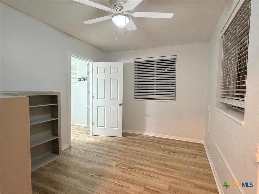 425 Woodland Point Road Belton, TX 76513 - Photo 6 of 27 a view of empty room with wooden floor and fan