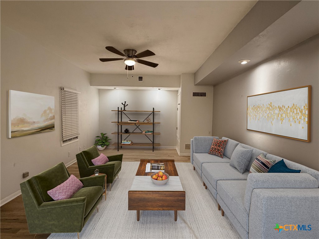 425 Woodland Point Road Belton, TX 76513 - Photo 8 of 27 a living room with furniture and a flat screen tv