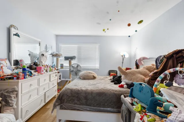 a bedroom with bed and a window