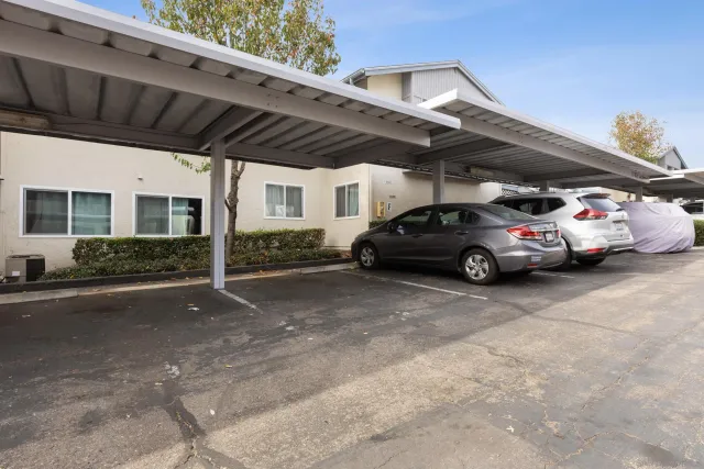 a view of parking garage with cars parked