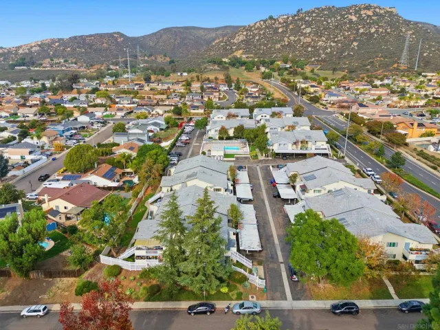 an aerial view of residential houses with outdoor space