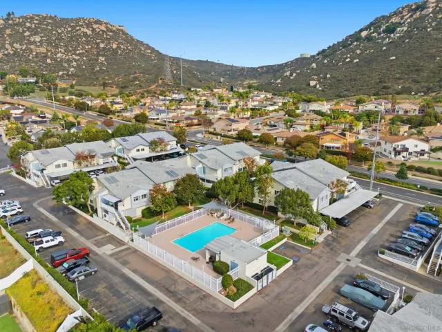 an aerial view of residential houses with outdoor space