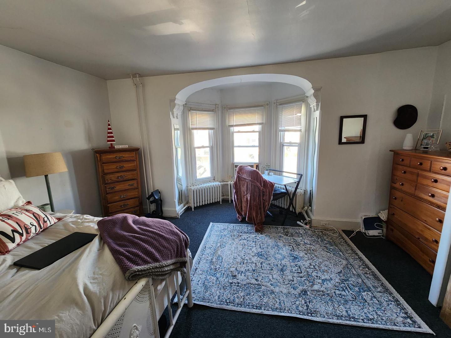 218 Osborn Street, Unit 2 Philadelphia, PA 19128 - Photo 2 of 6 a bedroom with a bed and wooden floor