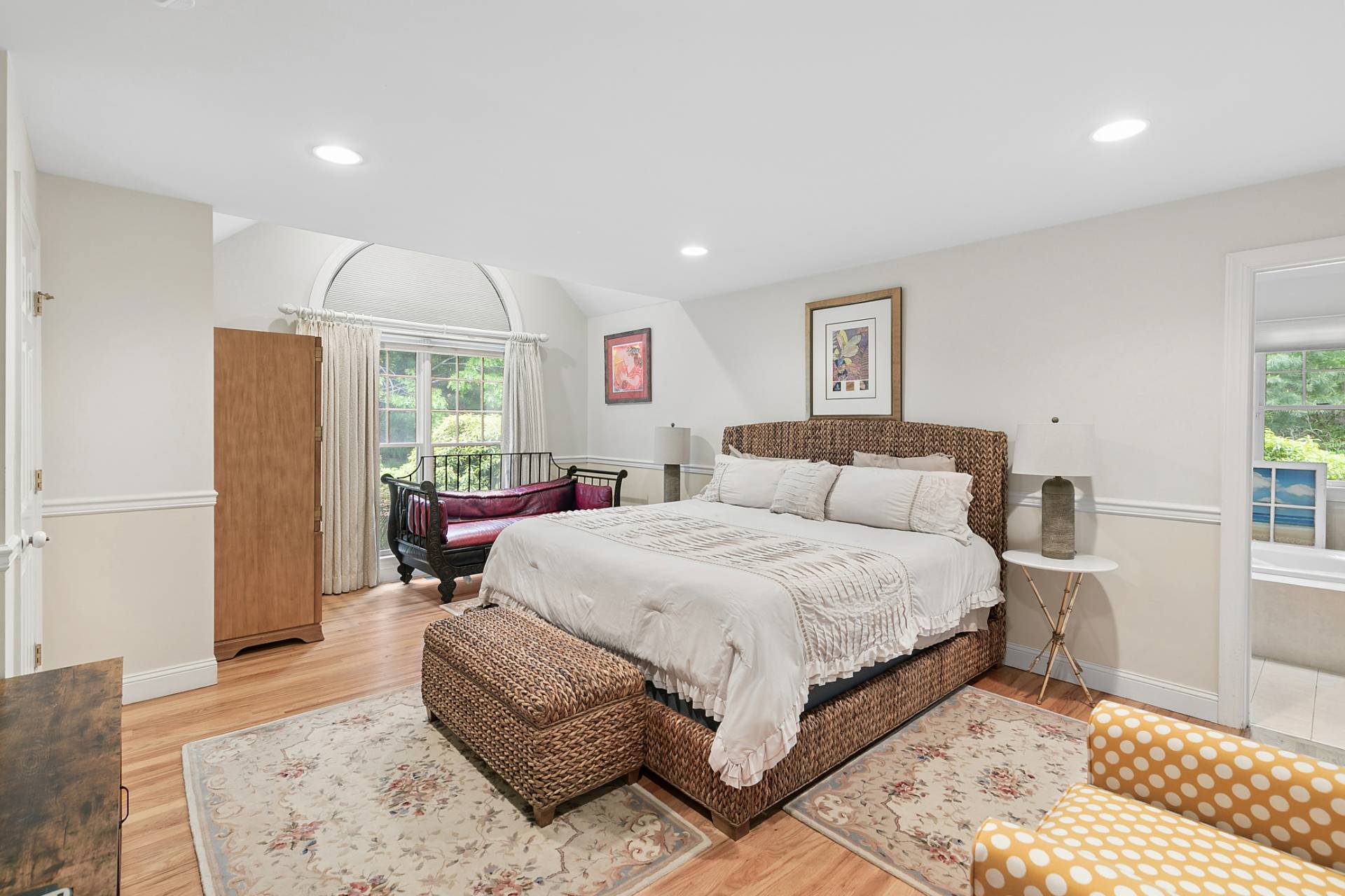 1557 Millstone Road Sag Harbor, NY 11963 - Photo 6 of 12 a spacious bedroom with a bed a couch and a window in it