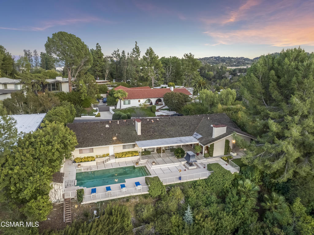 an aerial view of house with yard swimming pool and outdoor seating