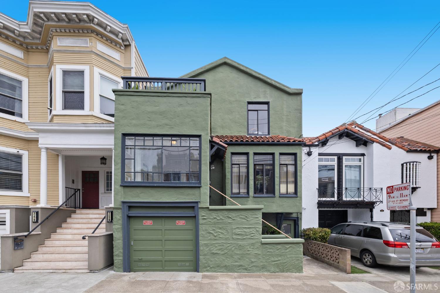 a front view of a house with a garden and entryway