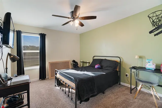 a bed room with a bed and a chair